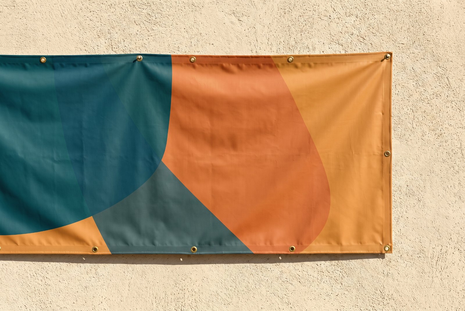 Grommeted outdoor vinyl banner on a wall