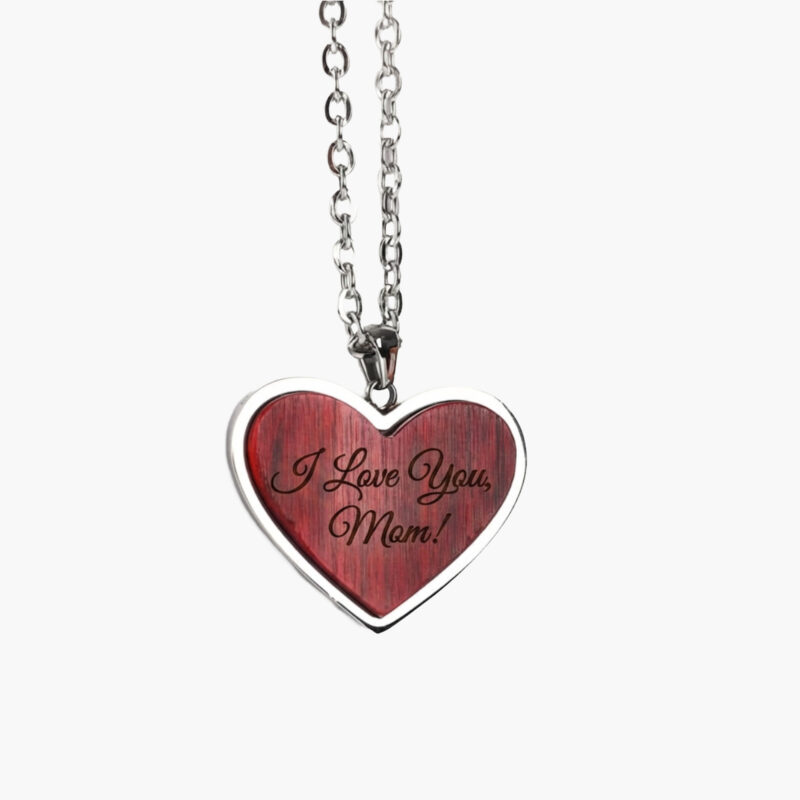A silver chain necklace with a red heart-shaped pendant engraved with the words "I Love You, Mom!" on a white background.